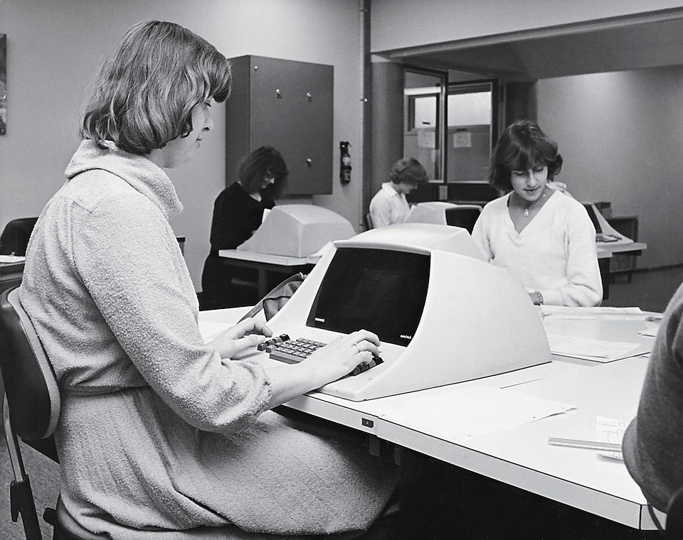 Women at desks working on computers